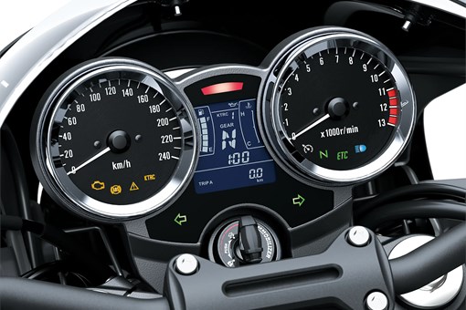 Close-up of the gauges of a motorcycle staged in a white studio background. opens in a new window
