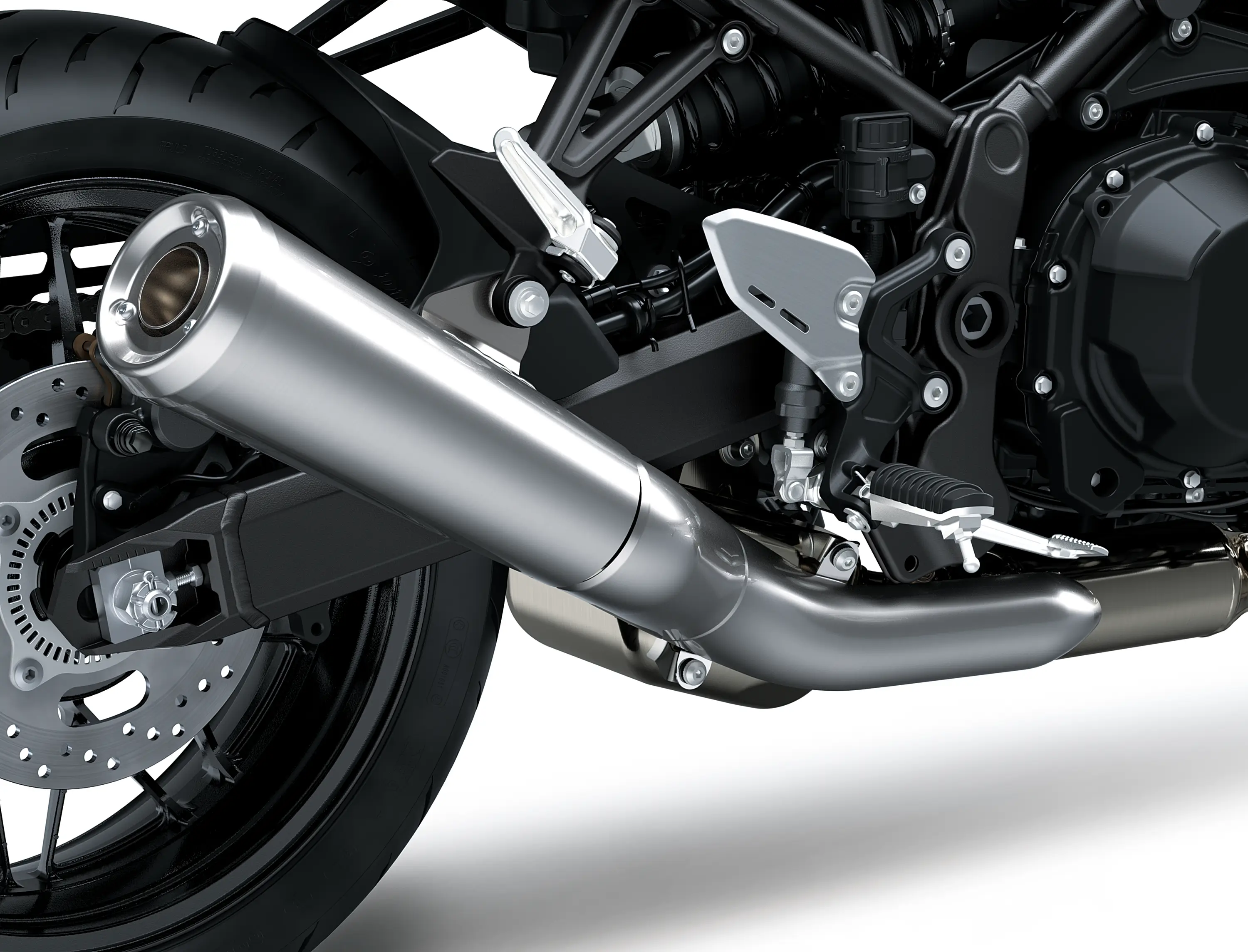 Close-up of the exhaust of a motorcycle staged in a white studio background.