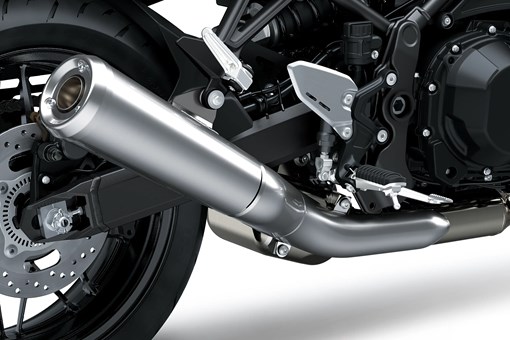 Close-up of the exhaust of a motorcycle staged in a white studio background. opens in a new window