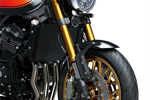 Close-up of the front end of a black motorcycle staged in a white studio background. opens in a new window