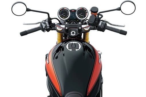 Rider POV of the handlebars of a motorcycle staged in a white studio background. opens in a new window