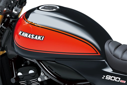 Close-up of the fuel tank of a motorcycle staged in a white studio background. opens in a new window