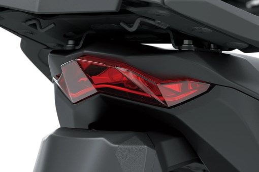 Taillight of a motorcycle staged in a white studio background. opens in a new window