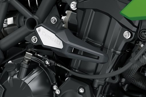 Side engine detail of a motorcycle staged in a white studio background. opens in a new window