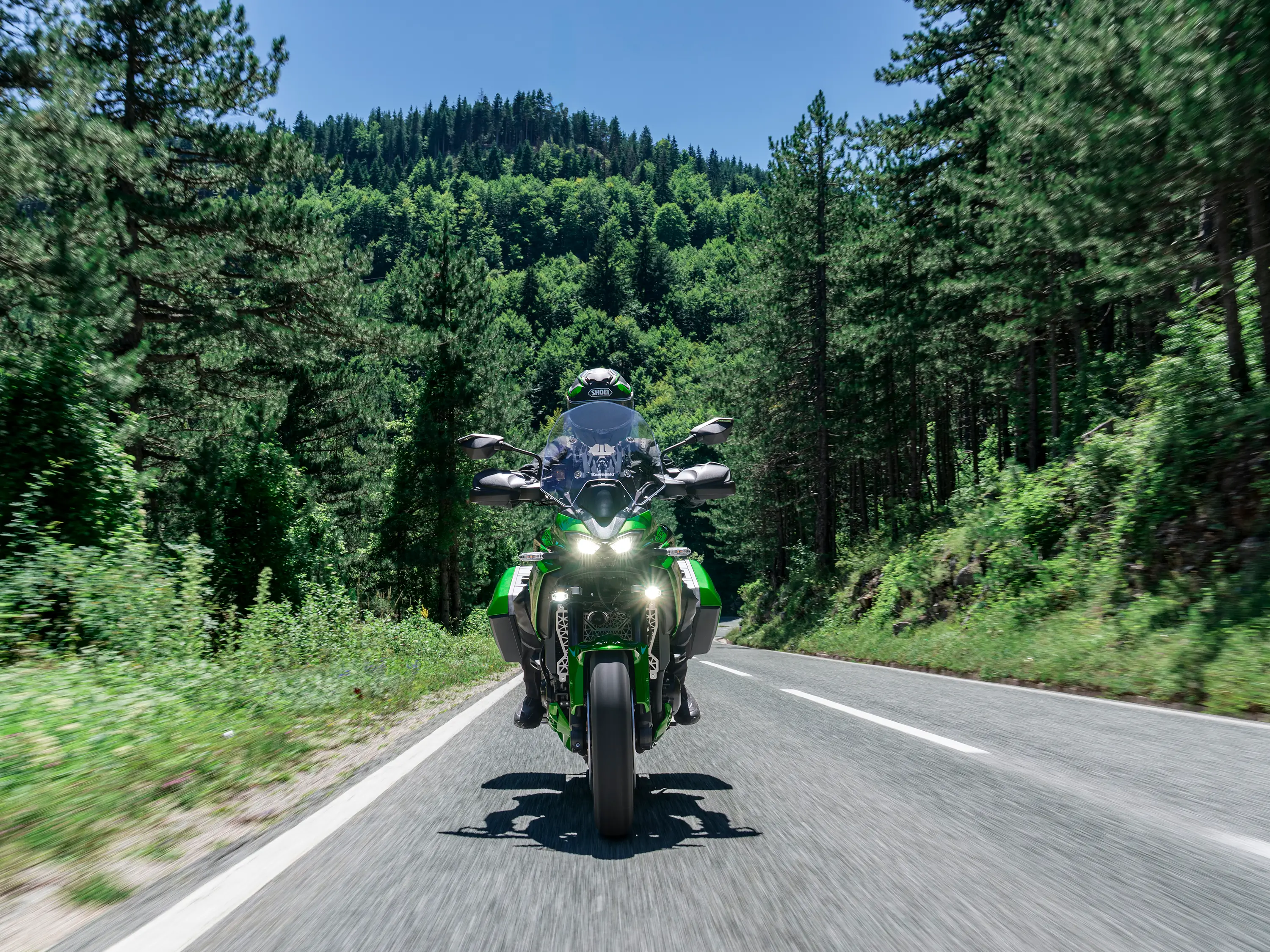 Front angle of a person riding a motorcycle on a highway.