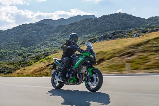 Side angle of a person riding a motorcycle on a highway. opens in a new window