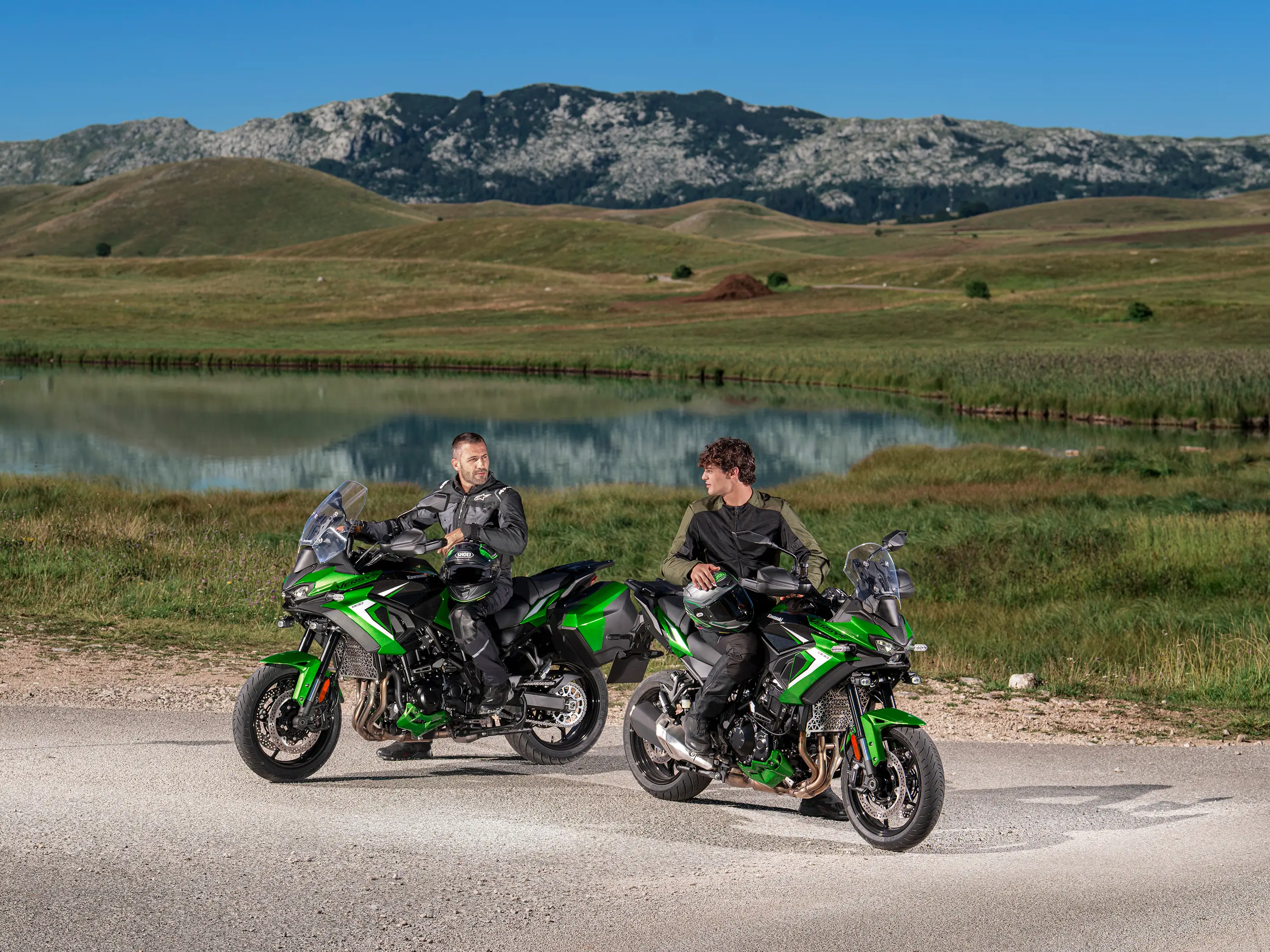 Three-quarter front angle of two motorcycles parked.