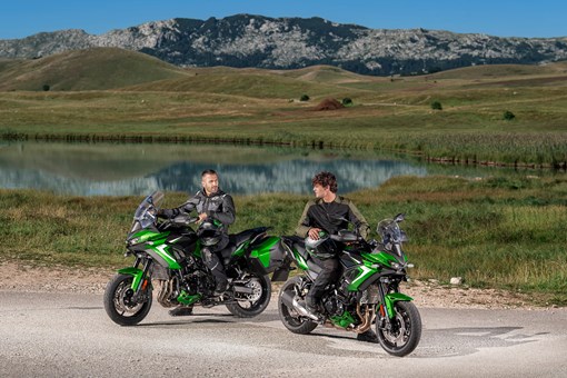 Three-quarter front angle of two motorcycles parked. opens in a new window