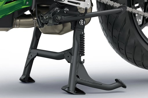 Motorcycle stand under a motorcycle staged in a white studio background. opens in a new window