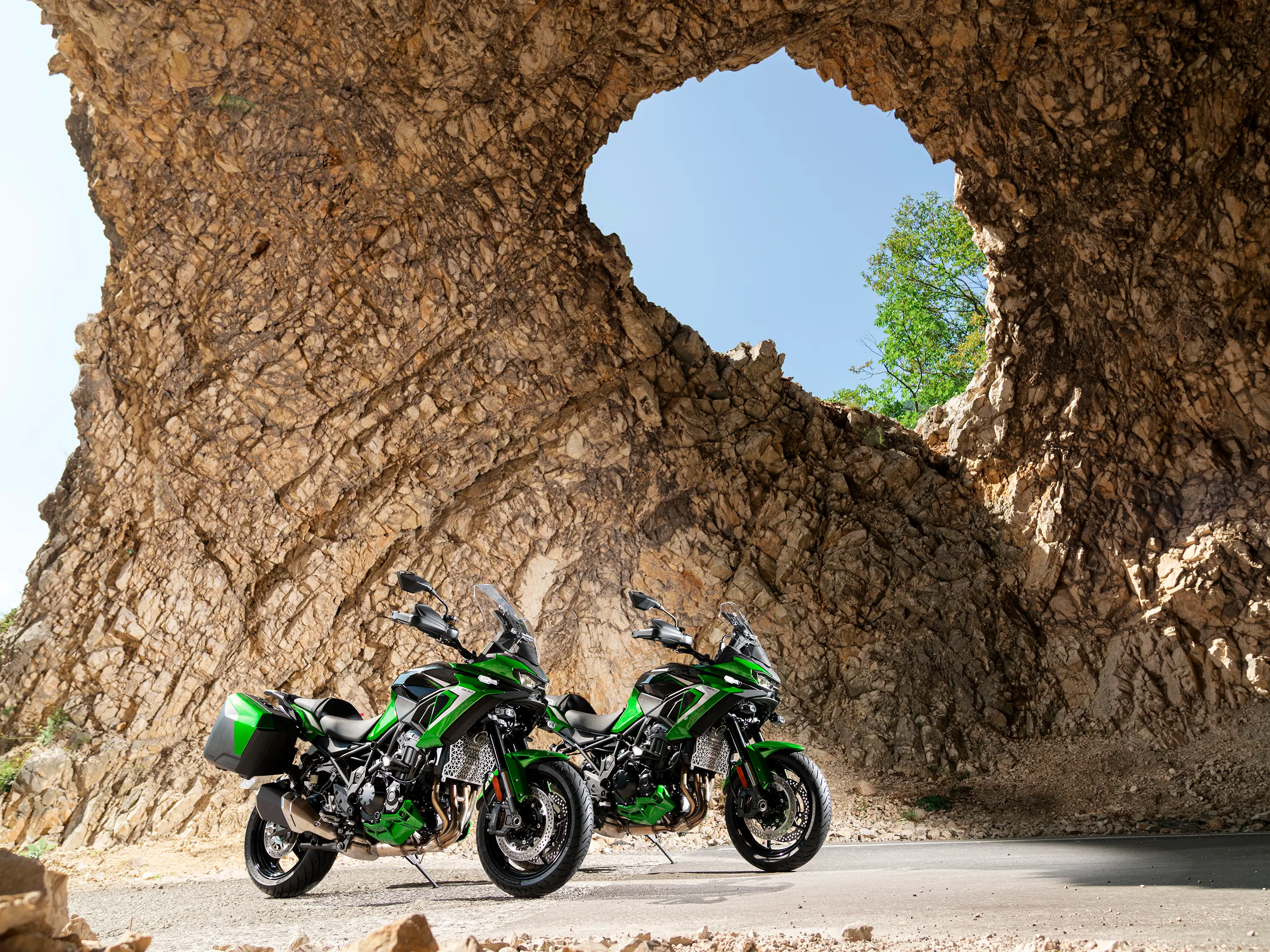 Three-quarter front angle of two motorcycles parked.