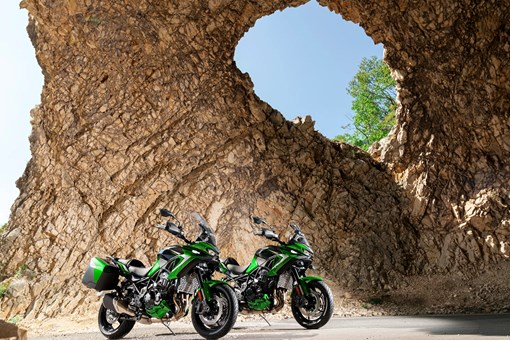 Three-quarter front angle of two motorcycles parked. opens in a new window