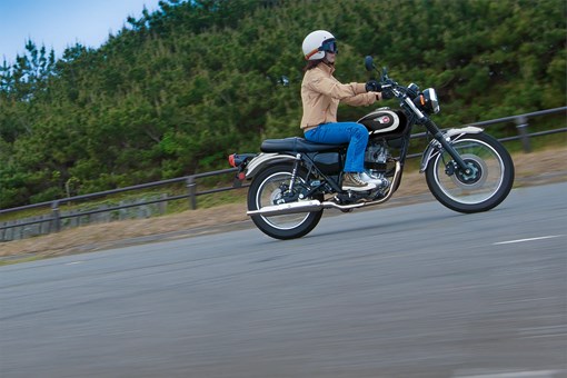 Side angle of a person riding a motorcycle on the street. opens in a new window