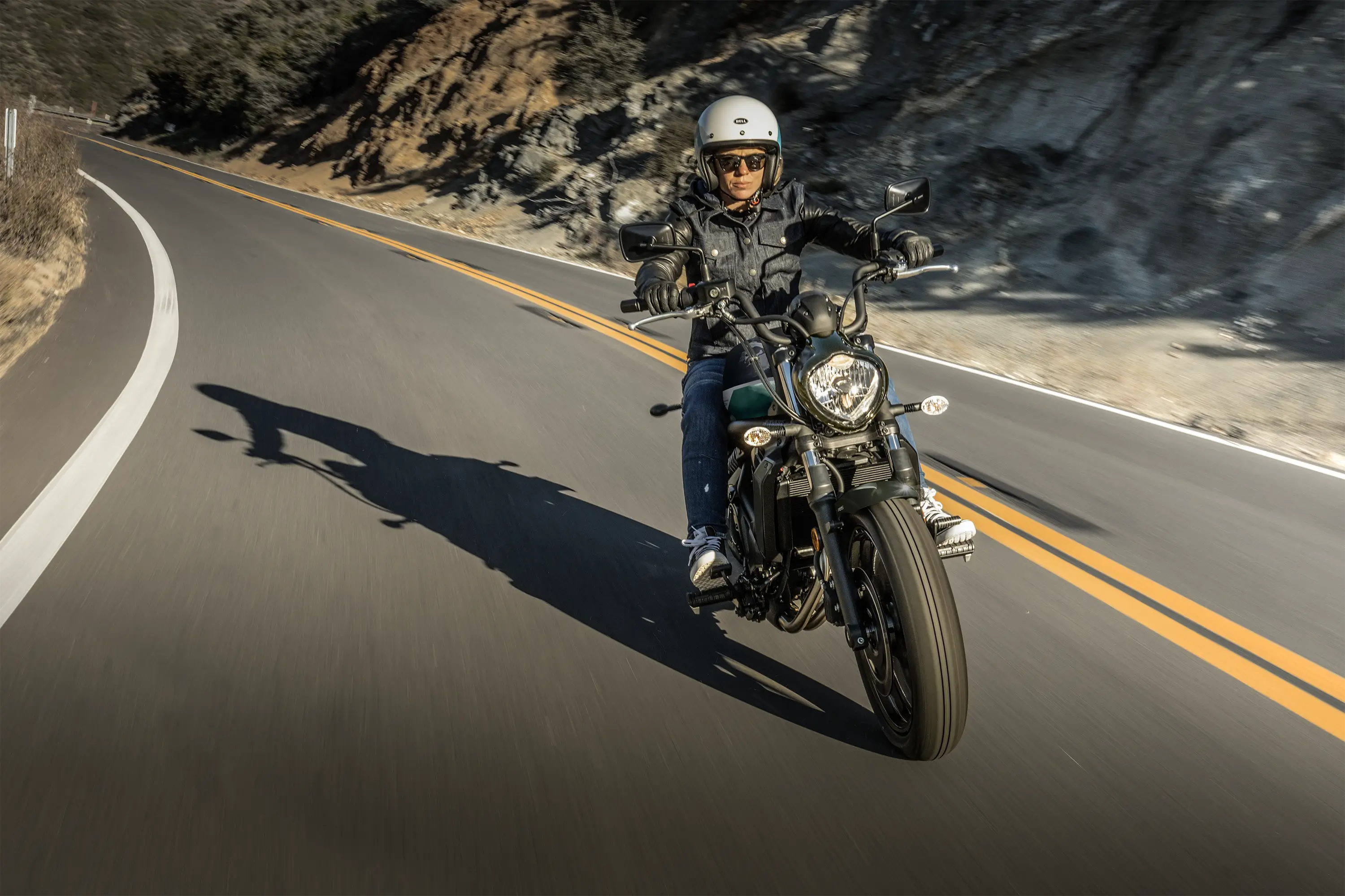 Front angle of a person riding motorcycles on the street.