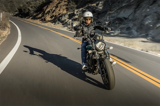 Front angle of a person riding motorcycles on the street. opens in a new window