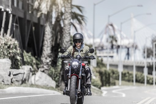 Front angle of a person riding a motorcycle on the street. opens in a new window