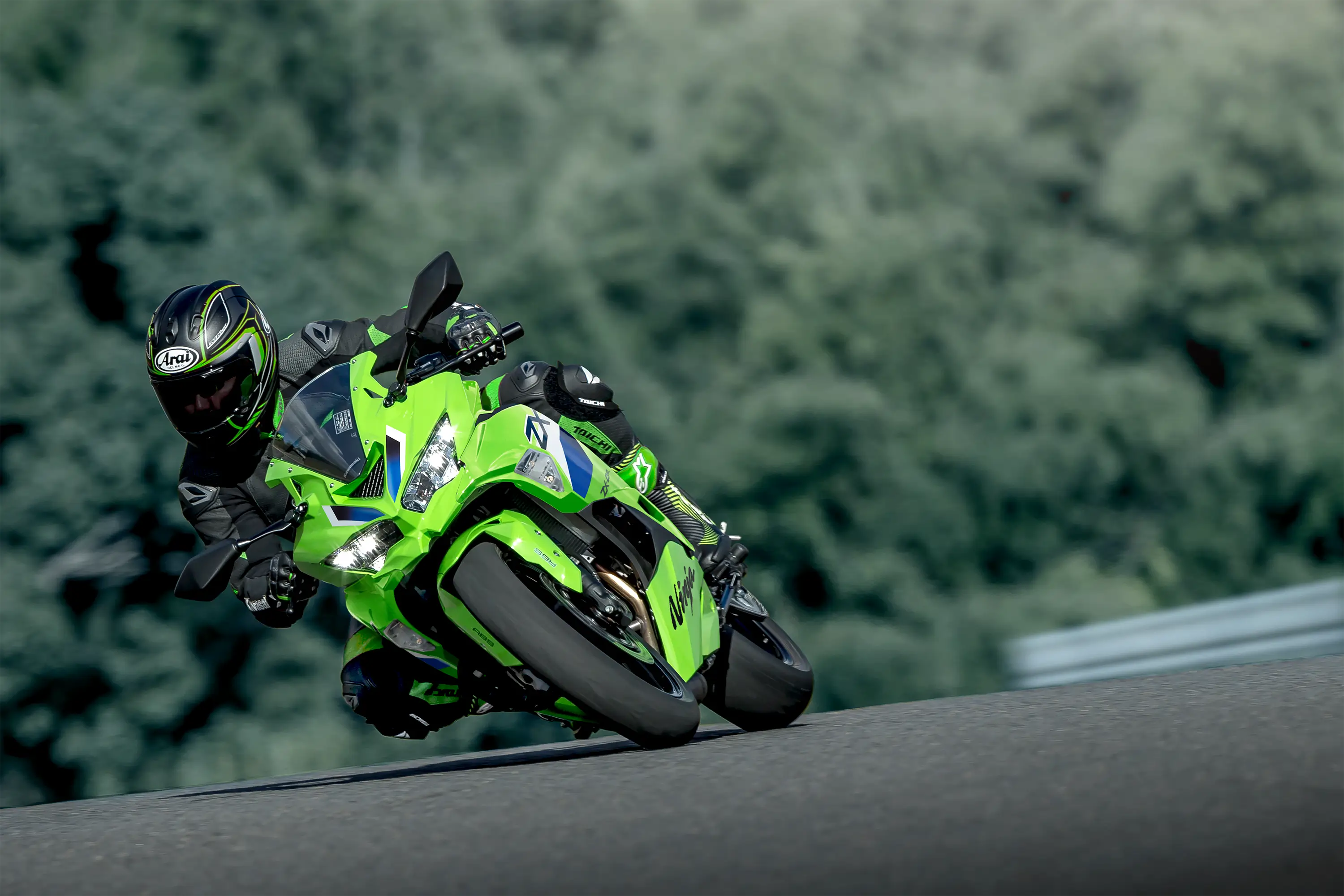 Front angle of a person riding a motorcycle and turning on a racetrack.