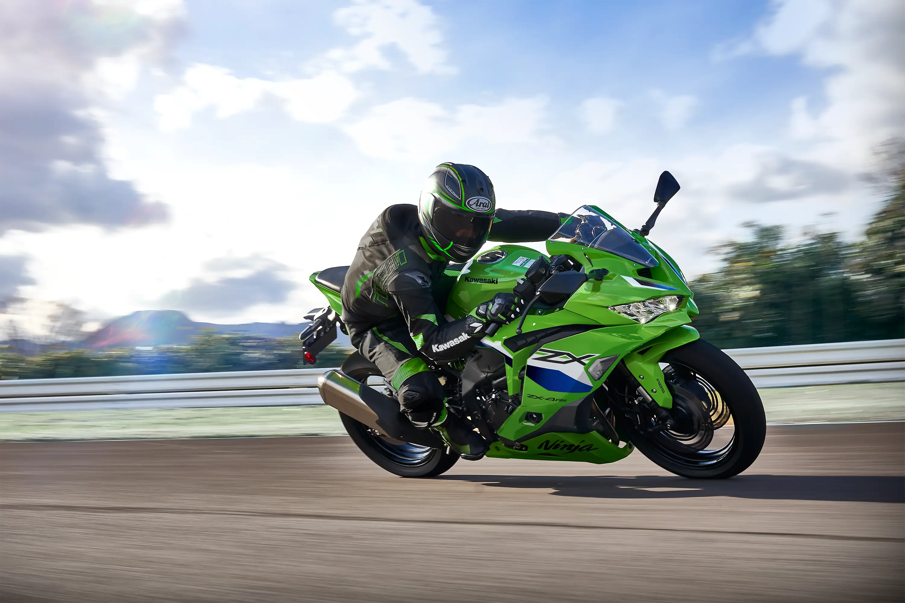 Side angle of a person riding a motorcycle on a racetrack.