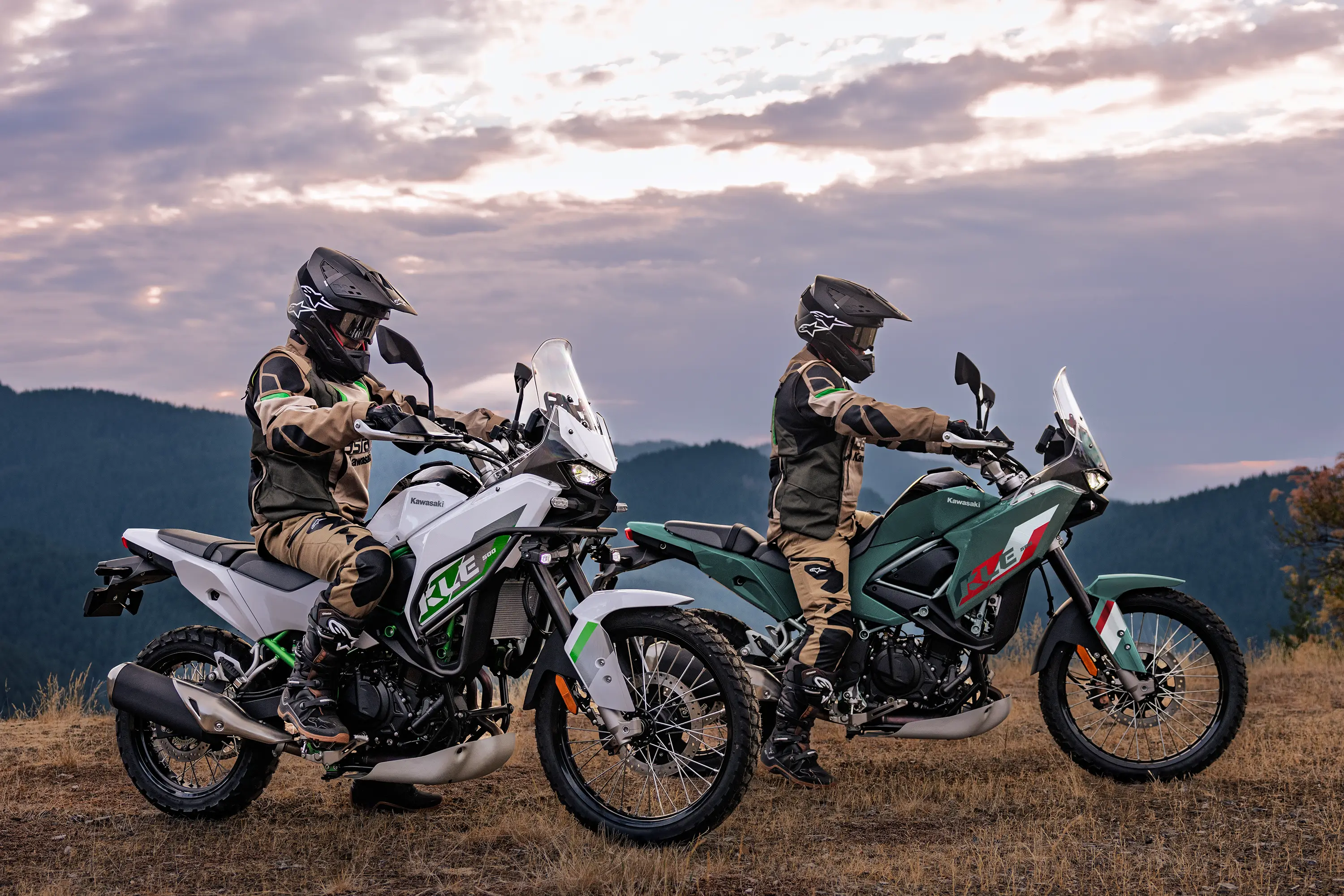 Side angle of two motorcycles parked off-road.