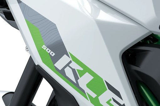 Side close on model logo of a motorcycle staged in a white studio background. opens in a new window