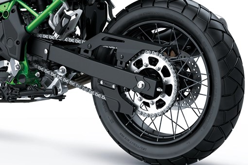 Closeup of a rear wheel of a motorcycle staged in a white studio background. opens in a new window