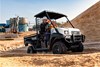 Three-quarter front angle of a person driving a side x side off-road.