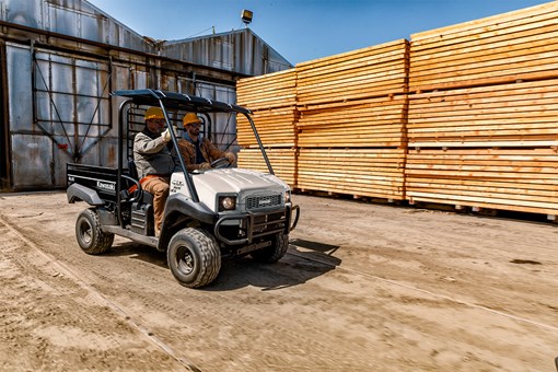 Three-quarter front angle of two people in a side x side off-road. opens in a new window
