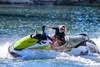Side angle of a person on a personal watercraft on the water.