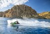 Three-quarter front angle of a person on a personal watercraft on the water. 