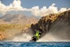 Front angle of a person on a personal watercraft on the water.