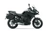 Side angle of a black motorcycle staged in a white studio background.