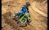 Three-quarter front angle of a person riding a motorcycle on a track.