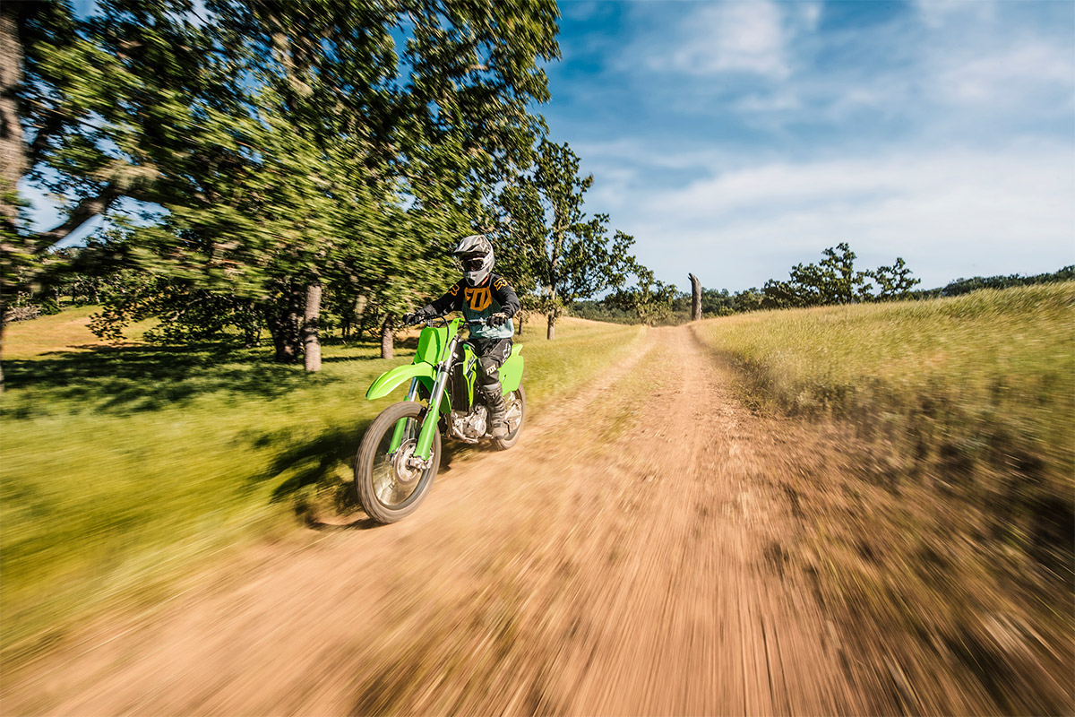 Three-quarter front angle of a person riding a motorcycle off-road.