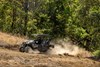 Profile angle of a person driving a side x side off-road.