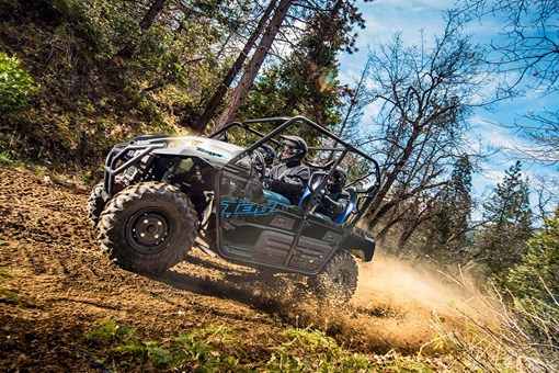 Side angle of a person driving a side x side off-road. opens in a new window
