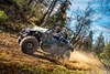 Side angle of a person driving a side x side off-road.