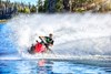 Front angle of a person on a personal watercraft on the water.
