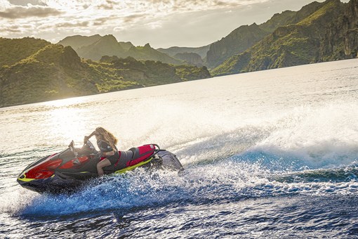 Profile angle of a person riding a personal watercraft on the water. opens in a new window