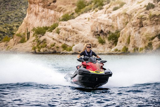 Front angle of a person riding a personal watercraft on the water. opens in a new window