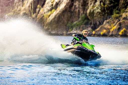 Front angle of a person on a personal watercraft on the water. opens in a new window