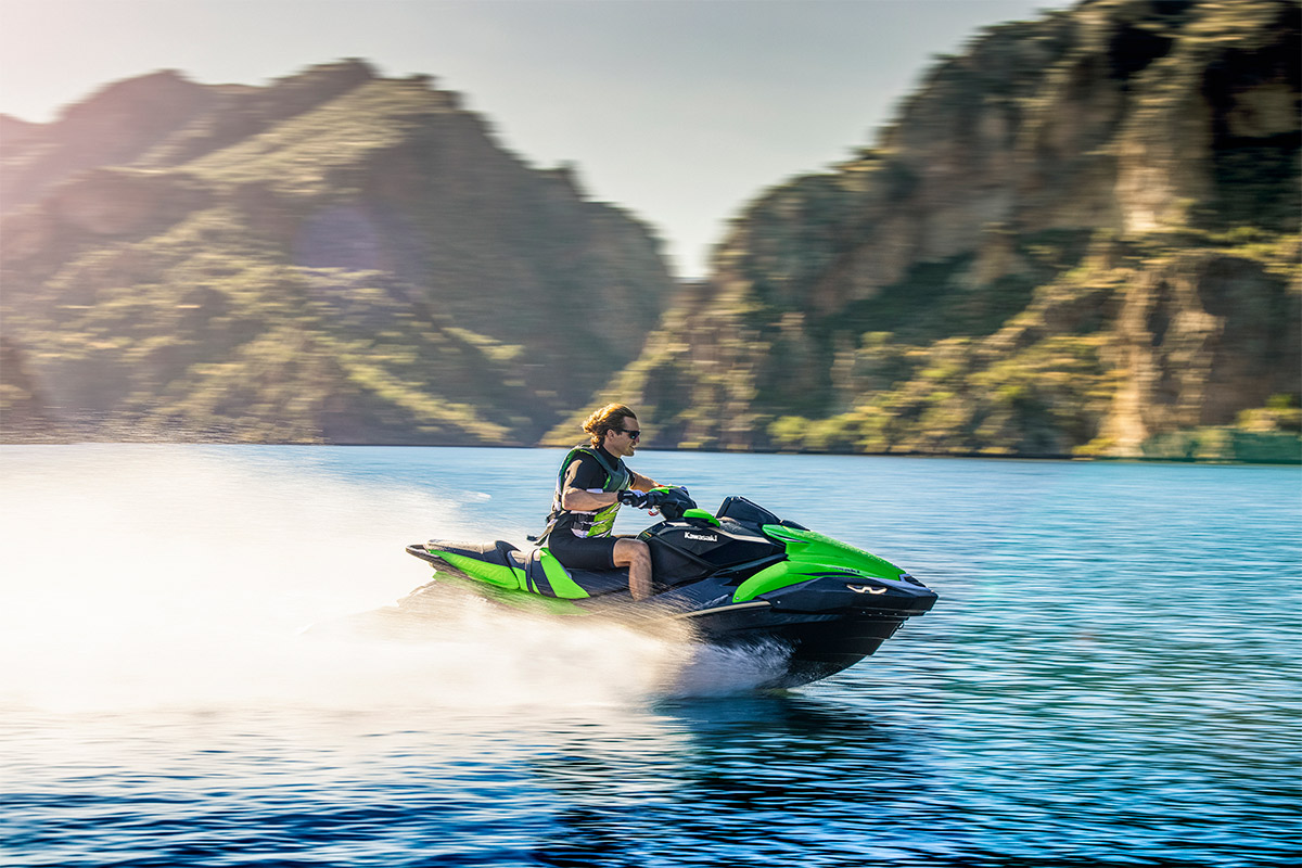 Profile angle of a person on a personal watercraft on the water.