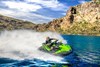 Side angle of a person on a personal watercraft on the water.