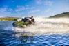 Side angle of a person on a personal watercraft on the water.