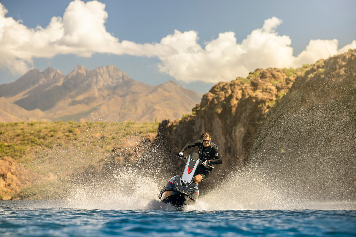 Front angle of a person on a personal watercraft on the water.