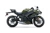 Side angle of a dark green motorcycle staged in a white studio background.