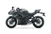 Profile angle of a motorcycle with green accents staged in a white studio background.