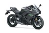 Three-quarter front angle of a motorcycle with green accents staged in a white studio background.