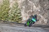 Front angle of a person riding a motorcycle on a winding road.