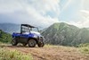 Three-quarter front angle of a side x side parked off-road.
