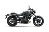 Side angle of a gray motorcycle staged in a white studio background.