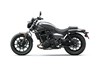 Profile angle of a gray motorcycle staged in a white studio background.